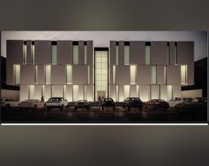 een groot gebouw met auto's geparkeerd op een parkeerplaats bij شقة بغرفتي نوم بتصميم أنيق مع مدخل خاص in Riyad