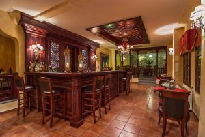 a bar in a restaurant with chairs and tables at Hotel Doupiani House in Kalabaka