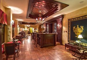 a restaurant with a bar in a room with chairs at Hotel Doupiani House in Kalabaka
