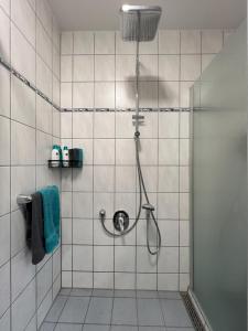 a bathroom with a shower with a blue towel at WOHNTRAUM in Altendiez in Altendiez