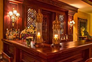 a bar with candles on top of a wooden table at Hotel Doupiani House in Kalabaka