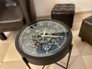 a clock with gears on it in a room at Al Duomo di Cagliari in Cagliari