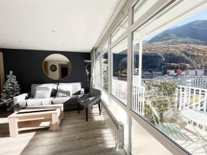 a living room with a couch and a large window at Casco Antiguo, Balcón Vistas, 10pax - 3Parkings l by BonesVacances in Andorra la Vella