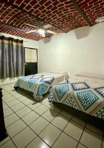 two beds sitting next to each other in a room at Villas de Morenos in Buenavista