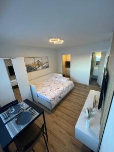a small room with a bed and a table at Studio au centre des 4 vallées in Nendaz