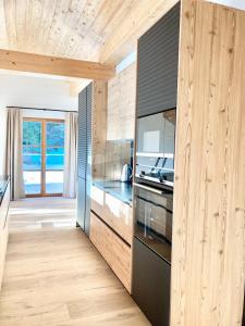a kitchen with wooden walls and wooden flooring at Alpen Luxury Lodge, MARIAZELL in Mariazell