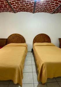 two beds sitting next to each other in a room at Villas de Morenos in Buenavista