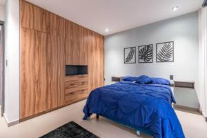 1 dormitorio con 1 cama y una gran pared de madera en Depa Industrial Moderno y Comodo, en Durango