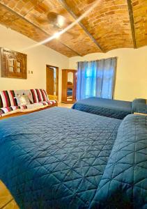 um quarto com uma grande cama azul e um sofá em Villas de Morenos em Buenavista