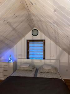 a bedroom with two beds and a window at Domek u Gołąbków Bieszczady in Lesko