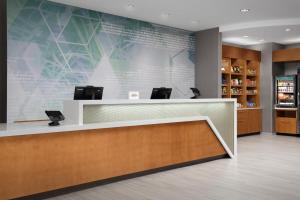 a lobby of a pharmacy with a reception desk at SpringHill Suites by Marriott Fayetteville I-95 in Fayetteville