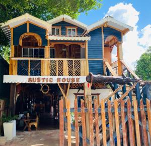 a large blue house with a rustic house at Rustic House 2 in Punta Rucia