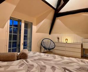 a bedroom with a large bed and a window at Appartement Cosy Nemours in Nemours