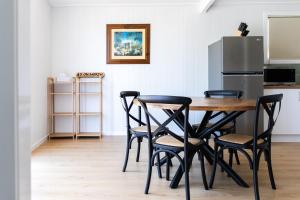a kitchen with a table and four chairs and a refrigerator at 40 On North. in Wondoan