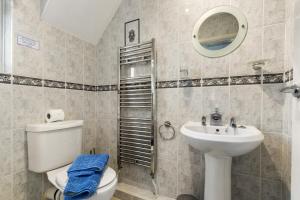 a bathroom with a toilet and a sink at Four Oaks - Sea and Harbour Views in Saundersfoot +26 photos