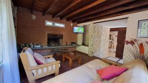 ein Wohnzimmer mit Couch und Kamin in der Unterkunft ATENCIÓN Consultar disponibilidad antes de reservar in Mar de las Pampas