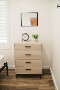 a dresser with a clock on it in a room at Hartman Center Campground in Milroy