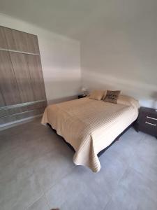 a bedroom with a large bed with a wooden cabinet at Alberdi 1218 in Colón