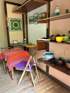 a kitchen with a table and a table and a chair at Departamento serrano in Nono