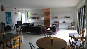 a living room with couches and tables and chairs at Elisetorp in Kivik