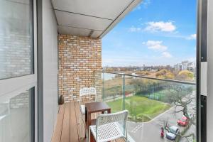 a balcony with a table and chairs and a view at Lake View Hackney Two Bed in London