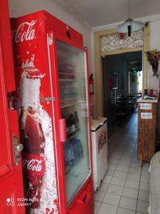 a coca cola bottle in a red refrigerator at Flora Pousada in Recife