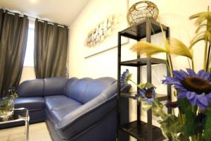 a living room with a blue couch and a shelf at Luxury Apartment in Praterstern area in Vienna