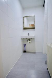 a white bathroom with a sink and a mirror at Luxury Apartment in Praterstern area in Vienna