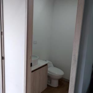 a bathroom with a toilet and a sink at Super Loft Sabaneta, Class48 Cerca a todo in Sabaneta