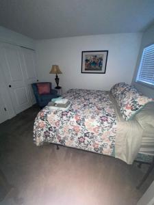 a bedroom with a bed with a floral comforter at Miami U Gallery Superior King Private Bedroom in Shared Apartment in Oxford