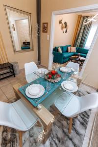 a dining table and chairs in a living room at Peaceful moments in Athens