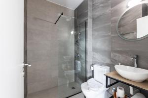 a bathroom with a toilet and a sink and a mirror at Pagani Green - Luxury Studio A2 in Faraí