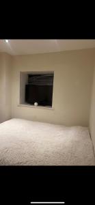a bedroom with a white bed with a window at Casa Amor Homes in Shrewsbury