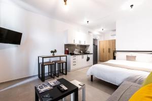 a hotel room with a bed and a kitchen at Pagani Green - Luxury Studio A3 in Kalamata