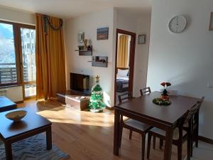 a living room with a table and a christmas tree at M&R Apartment C13 - SPA Terra Complex in Razlog