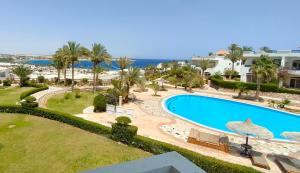 an image of a swimming pool at a resort at Naama Bay, 2BR Pool and sea view, Center Naama Bay Sharm El-Sheikh in Sharm El Sheikh