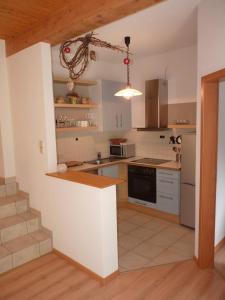 a kitchen with white cabinets and a counter top at Haus zur Eule in Todtnau