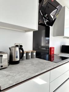 a kitchen with a counter top with a tea kettle at Brand New 3 bedroom House in Gated Development! in Polesworth
