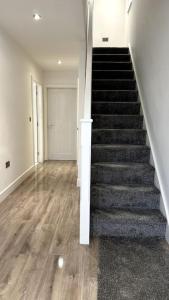 an empty room with a staircase in a house at Brand New 3 bedroom House in Gated Development! in Polesworth