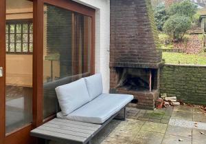 a couch sitting on a patio with a fireplace at My Loft by Essen 2 Apartments in Rosengarten