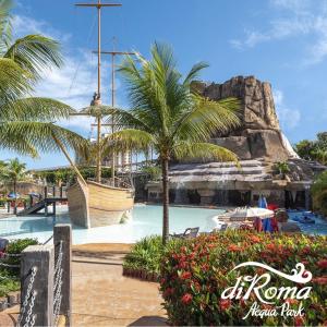 a pool with a pirate ship in a theme park at Spazzio Diroma Acqua Park Luxo in Caldas Novas