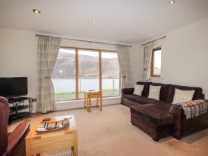 a living room with a couch and a tv at Tigh na Creag in Sconser