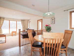 a dining room and living room with a table and chairs at Tigh na Creag in Sconser