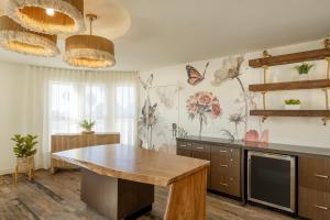 a kitchen with a wooden table and butterflies on the wall at Cardiff By The Sea Lodge in Encinitas