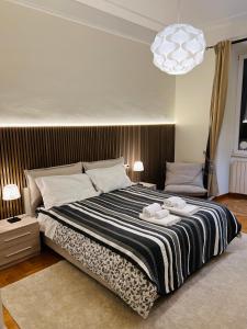 a bedroom with a large bed with two towels on it at Prati Dream House in Rome