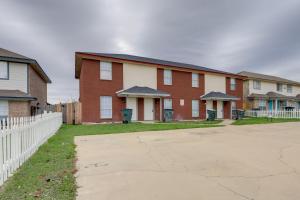 a row of houses with a white fence at Quaint Killeen Vacation Rental Near Shopping! in Killeen