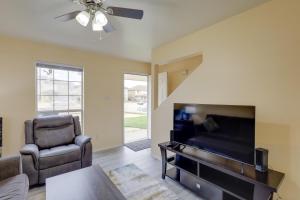 a living room with a flat screen tv and a chair at Quaint Killeen Vacation Rental Near Shopping! in Killeen