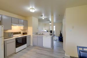 an empty kitchen with white cabinets and appliances at Quaint Killeen Vacation Rental Near Shopping! in Killeen