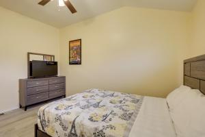 a bedroom with a bed and a dresser with a television at Quaint Killeen Vacation Rental Near Shopping! in Killeen