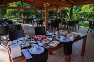 a table with plates of food on it at Apella Hotel in Cıralı